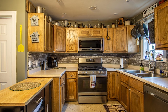 20 Hemlock Subdivision Rd, Williamsburg, KY 40769 - kitchen with appliances with stainless steel finishes, a sink, light tile patterned flooring, and tasteful backsplash