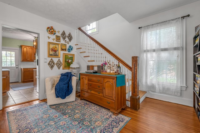 stairs featuring wood finished floors