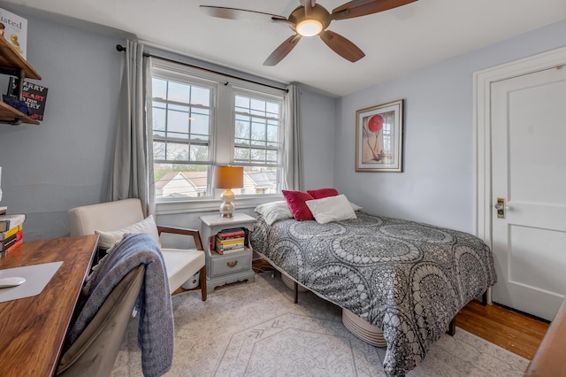 bedroom with wood finished floors and ceiling fan