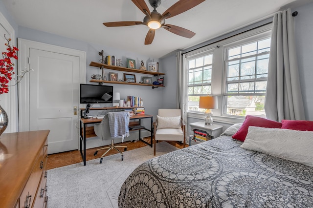 bedroom featuring a ceiling fan and wood finished floors