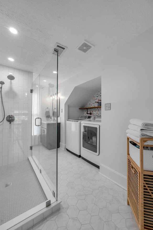 bathroom featuring washer and dryer, recessed lighting, visible vents, and a stall shower