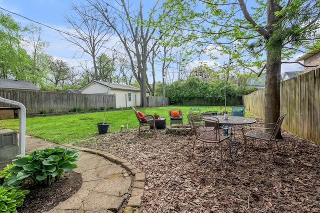 view of yard with a fenced backyard and a fire pit