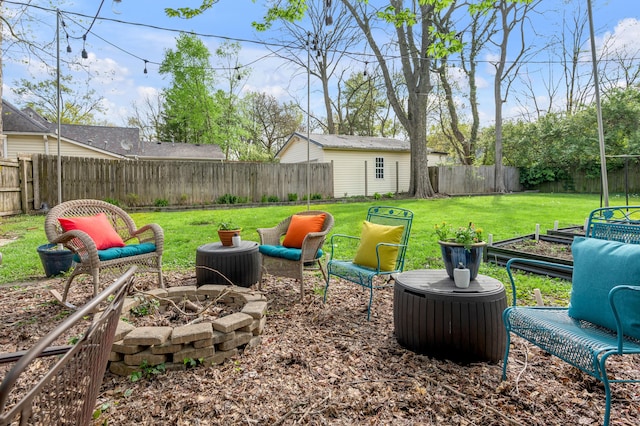 view of yard featuring a fenced backyard and an outdoor fire pit