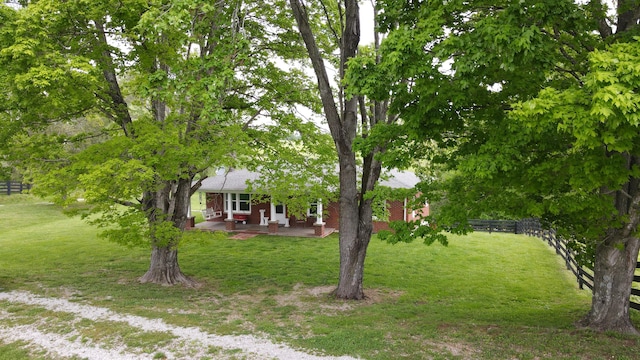 view of yard featuring fence and a patio area