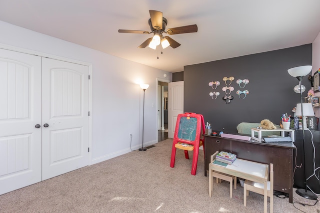 office space with carpet, a ceiling fan, and baseboards