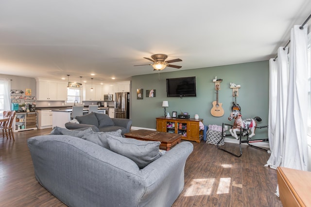 living room featuring a ceiling fan, recessed lighting, and dark wood finished floors