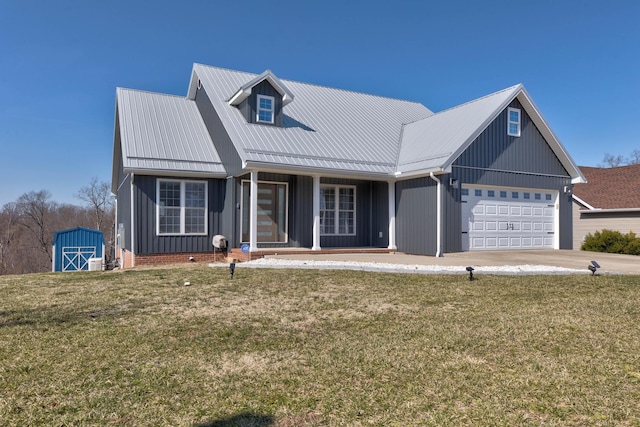 5141 Tristin Way, Catlettsburg, KY 41129 - view of front of home featuring board and batten siding, metal roof, a shed, a front lawn, and an attached garage