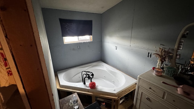 bathroom featuring a whirlpool tub and vanity