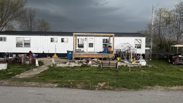manufactured / mobile home featuring a deck and metal roof