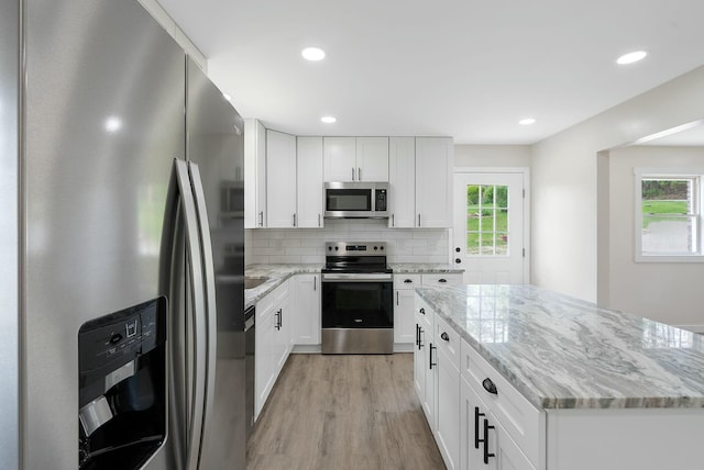 730 E Spencer Rd, Campton, KY 41301 - kitchen featuring light stone counters, light wood-type flooring, stainless steel appliances, and plenty of natural light
