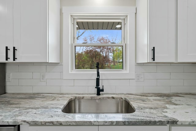 730 E Spencer Rd, Campton, KY 41301 - kitchen with light stone countertops, decorative backsplash, white cabinetry, and a sink