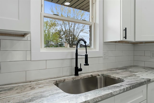 730 E Spencer Rd, Campton, KY 41301 - room details featuring light stone counters, decorative backsplash, white cabinetry, and a sink
