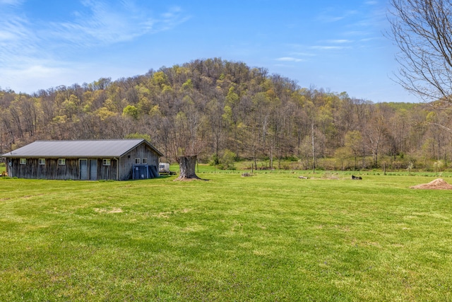6473 Wildie Rd, Mount Vernon, KY 40456 - view of yard with an outdoor structure, a view of trees, and a pole building