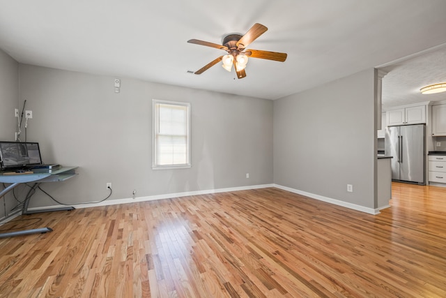 6473 Wildie Rd, Mount Vernon, KY 40456 - unfurnished living room featuring baseboards, a ceiling fan, and light wood-type flooring