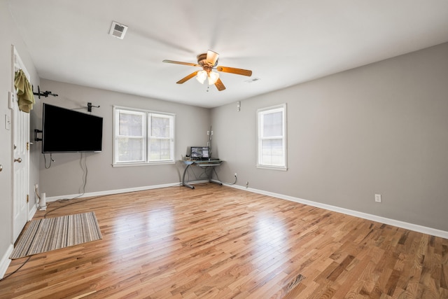 6473 Wildie Rd, Mount Vernon, KY 40456 - unfurnished living room with light wood-type flooring, a healthy amount of sunlight, and a ceiling fan