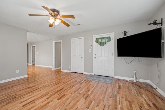 6473 Wildie Rd, Mount Vernon, KY 40456 - unfurnished living room with ceiling fan, baseboards, visible vents, and light wood-style flooring