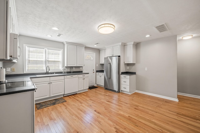 6473 Wildie Rd, Mount Vernon, KY 40456 - kitchen with dark countertops, white appliances, and a sink