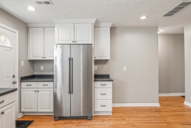 6473 Wildie Rd, Mount Vernon, KY 40456 - kitchen with dark countertops, high quality fridge, visible vents, and light wood-type flooring