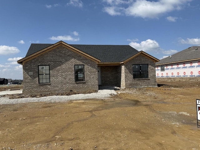property in mid-construction with brick siding