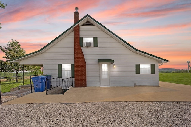 back of house featuring fence, a chimney, and a patio area