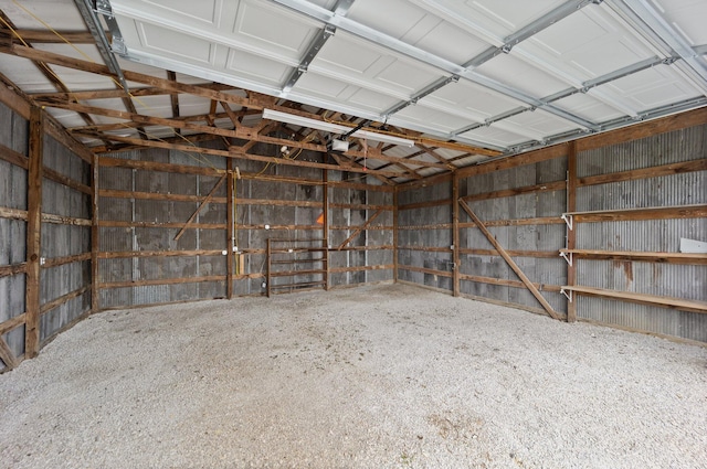 garage featuring a garage door opener and metal wall