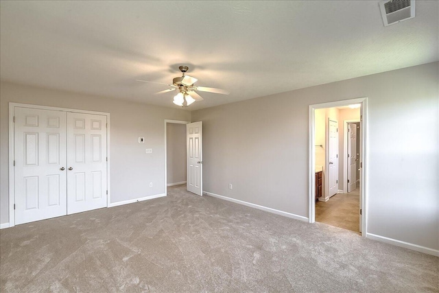 unfurnished bedroom featuring baseboards, visible vents, carpet, a ceiling fan, and a closet