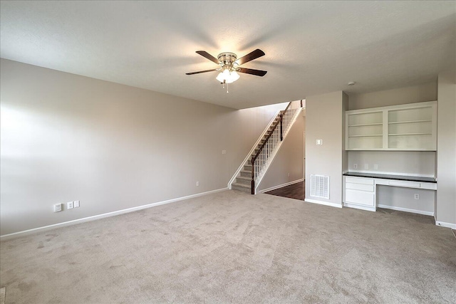 unfurnished living room with stairway, ceiling fan, carpet floors, baseboards, and visible vents