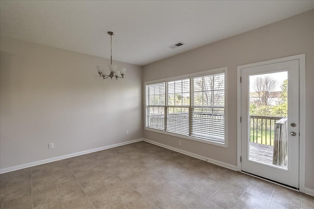unfurnished dining area with an inviting chandelier, visible vents, and baseboards