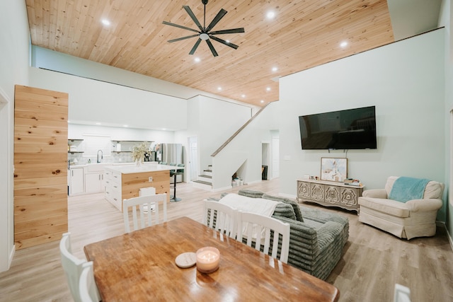 dining area featuring recessed lighting, light wood-style floors, wood ceiling, stairs, and ceiling fan
