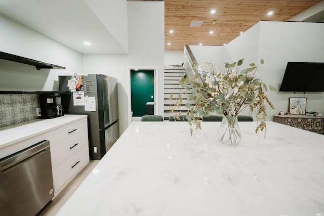 kitchen with white cabinets, recessed lighting, light stone countertops, wooden ceiling, and appliances with stainless steel finishes