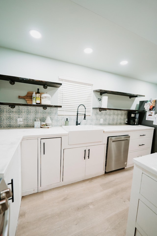 kitchen featuring open shelves, stainless steel dishwasher, white cabinets, and backsplash