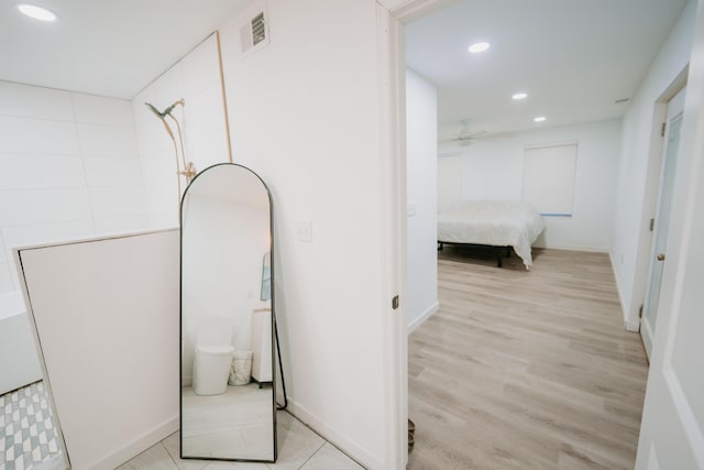 hallway with baseboards, visible vents, recessed lighting, and light wood-style floors