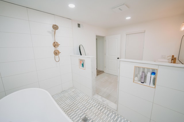 bathroom featuring a freestanding tub, visible vents, recessed lighting, and a tile shower