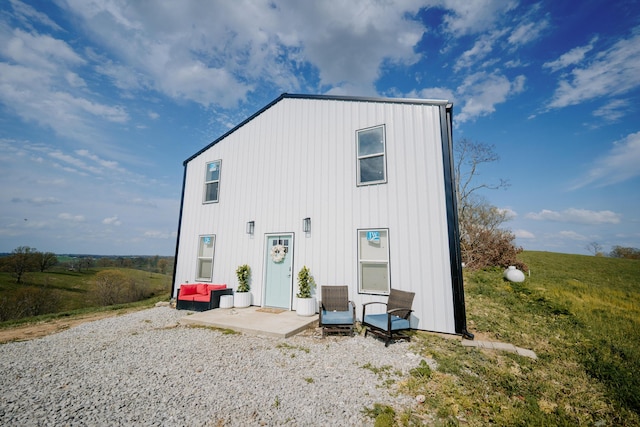 rear view of property with outdoor lounge area