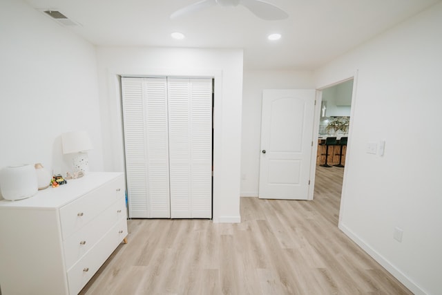 unfurnished bedroom with light wood-type flooring, baseboards, visible vents, recessed lighting, and a closet