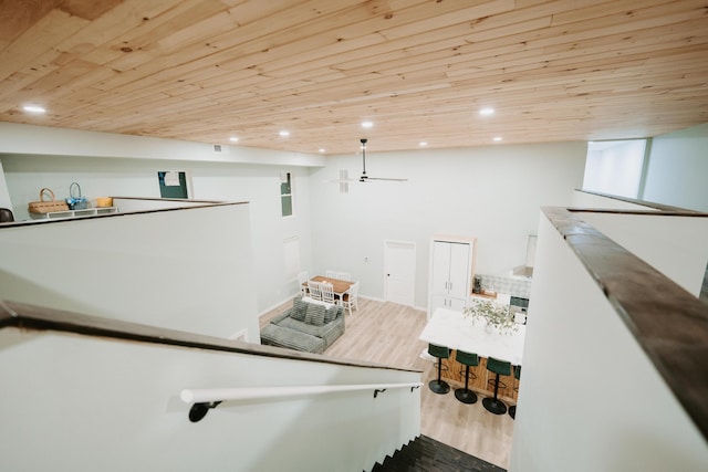 stairs with wood ceiling, baseboards, wood finished floors, and recessed lighting