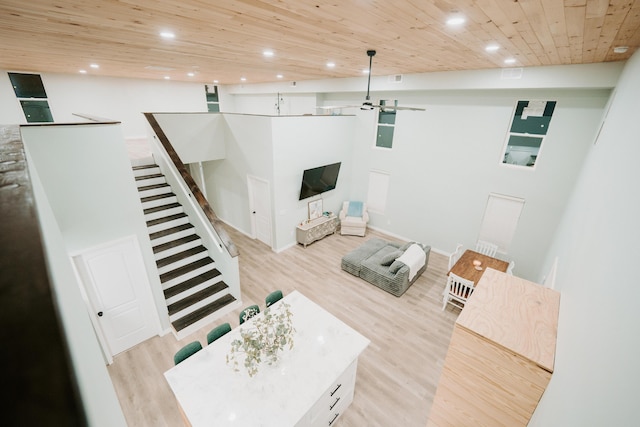 living area with wood ceiling, recessed lighting, light wood-style floors, and stairway