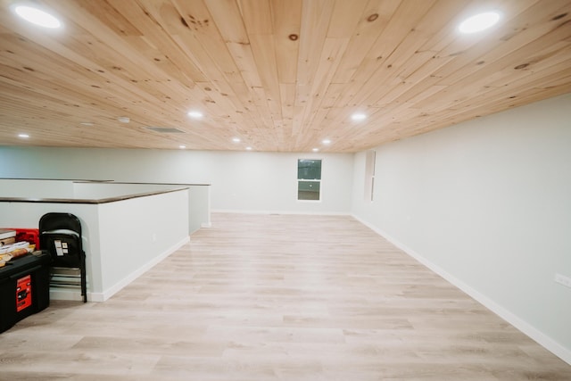 basement featuring baseboards, wooden ceiling, wood finished floors, and recessed lighting