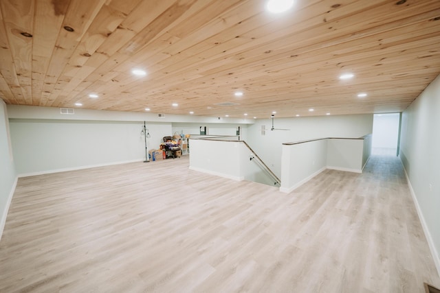finished below grade area with baseboards, light wood-style floors, visible vents, and recessed lighting
