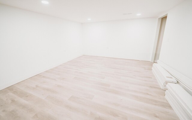empty room with recessed lighting and light wood-style flooring