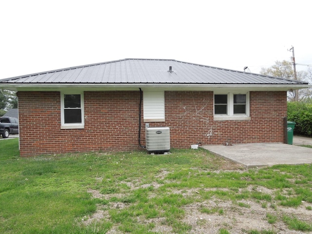 217 Dorothy Ave, Danville, KY 40422 - back of house featuring a lawn, a patio, cooling unit, metal roof, and brick siding