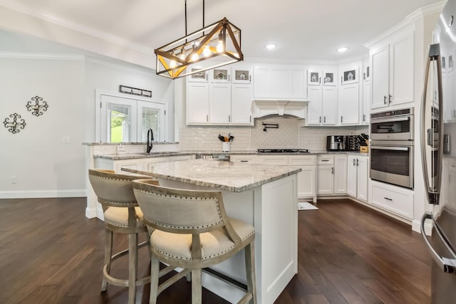 600 Avawam Dr, Richmond, KY 40475 - kitchen featuring dark wood finished floors, tasteful backsplash, stainless steel appliances, a sink, and crown molding