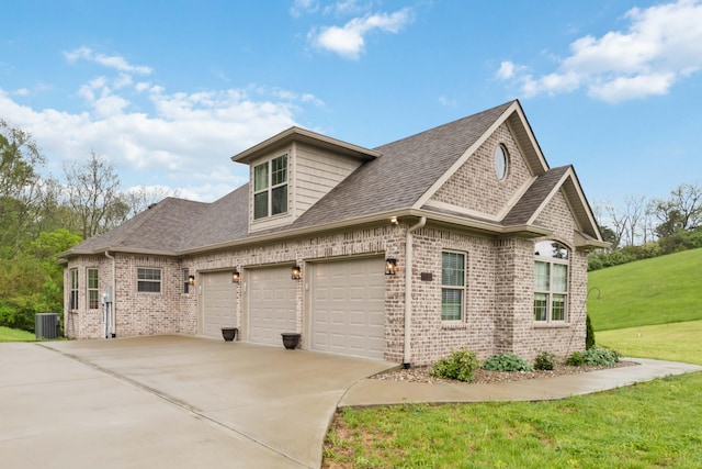 600 Avawam Dr, Richmond, KY 40475 - view of side of home featuring brick siding, driveway, central AC, roof with shingles, and an attached garage