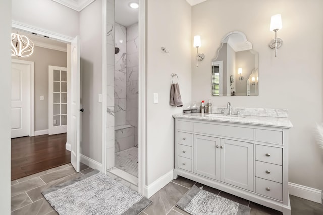 600 Avawam Dr, Richmond, KY 40475 - bathroom featuring baseboards, an inviting chandelier, ornamental molding, vanity, and tiled shower