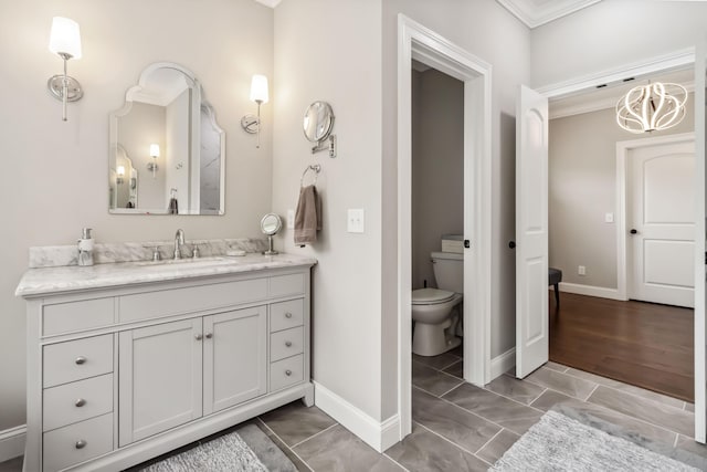 600 Avawam Dr, Richmond, KY 40475 - bathroom with vanity, a notable chandelier, toilet, baseboards, and ornamental molding
