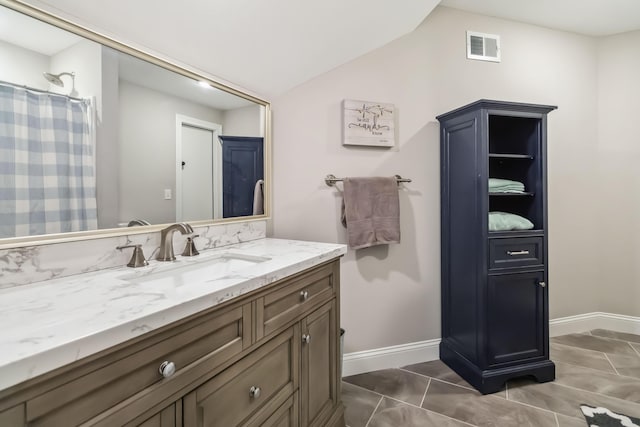 600 Avawam Dr, Richmond, KY 40475 - bathroom with tile patterned flooring, vaulted ceiling, vanity, baseboards, and visible vents