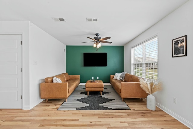 living room with wood finished floors, baseboards, a ceiling fan, and visible vents