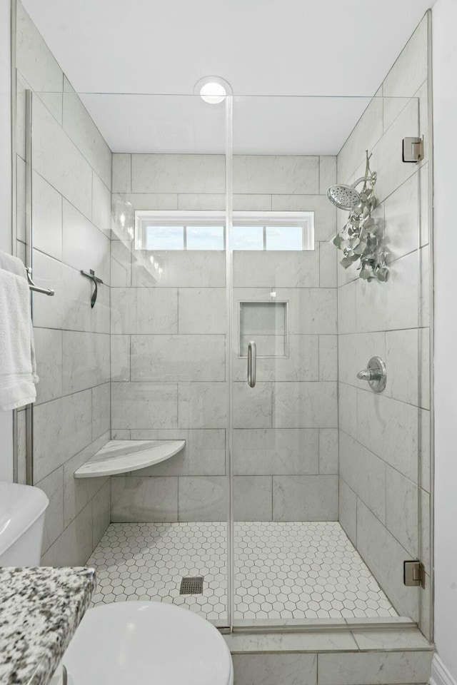 full bath with a shower stall and toilet