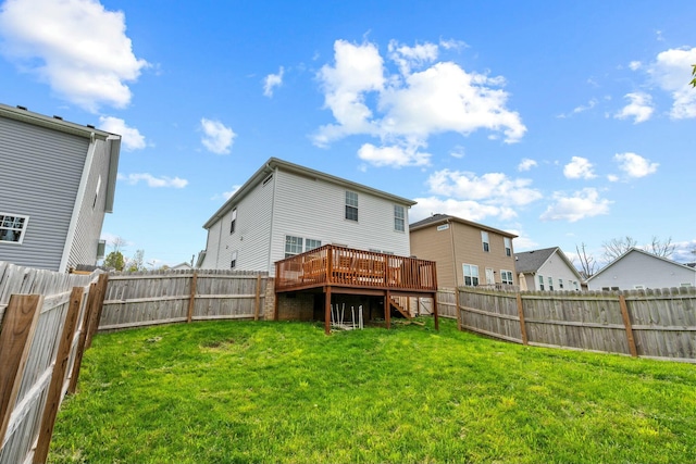 back of house with a fenced backyard, a wooden deck, stairway, and a yard