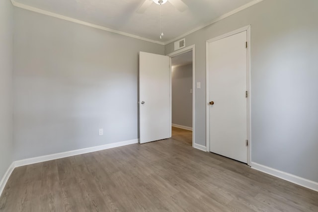 679 Mclain Rd, Springfield, KY 40069 - unfurnished bedroom with baseboards, wood finished floors, and visible vents